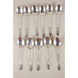 A set of six modern silver coffee spoons with floral cast terminals, Birmingham 1956, and a set of
