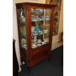 A rectangular display cabinet with glazed panel door enclosing mirror backed interior with two glass