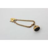 A 9ct gold curb link bracelet with padlock clasp and hung with a bloodstone fob seal, 12.8g