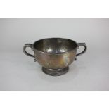 A George V silver two handled bowl on circular foot with leaf capped scroll handles, maker R & S