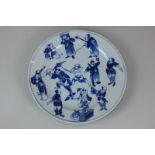 A Chinese blue and white porcelain plate decorated with figures in various poses, character mark