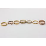 Two 22ct gold wedding rings, 8.4g, a 15ct gold mourning ring, 2.5g, and four 9ct gold rings, 10.4g