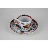 An early 19th century Masons Ironstone coffee cup and saucer, cylindrical shape with pinched handle,