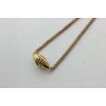 A gold snake link neck chain strung with an oval locket mounted with a coiled snake, 30.2g gross