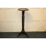 A mahogany jardiniere stand with circular top and carved reeded stem on outswept tripod legs, 41cm