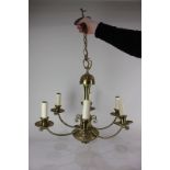A large brass six-branch chandelier light fitting, approximately 59cm
