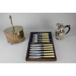 A silver plated biscuit box, a hot water jug, and an oak cased set of six fish knives and forks
