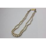 A two-row pearl necklace on a 9ct gold clasp