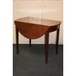 An inlaid mahogany Pembroke drop-leaf table with oval top and bow fronted end drawer, on square