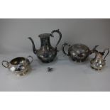 A Victorian four-piece silver plated tea set with engraved floral scrolling design, together with