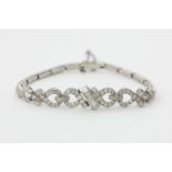A diamond bracelet channel and pave set with baguette and eight cut diamonds on an expanding