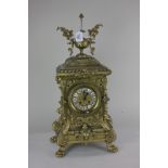 A Louis XVI style gilt metal mantel clock with four inch dial, cartouche shaped enamel Roman