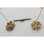 A 9ct gold flower head brooch, 6.5g, a 9ct gold and sapphire foliate brooch, and a bar brooch, 14.