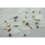 Nineteen pairs of earrings and studs in various metals