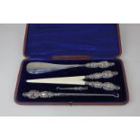 A Victorian silver mounted matched lady's set in case, with shoe horn, glove stretcher, and large