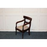 A Regency style miniature mahogany child's bar-back elbow chair with needlework upholstered drop-