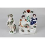 A 19th century porcelain cherub figure holding a basket of flowers, 12cm, and a Staffordshire flat