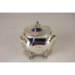 An Edward VII silver tea caddy of scalloped ovoid form on paw feet, marks worn, Birmingham 1905, 5.