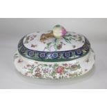 A Continental porcelain tureen and cover with fruit moulded finial, decorated with flowers and