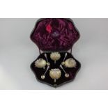 A Victorian cased silver set of four salt cruets, each cast in the form of scallop shell on three
