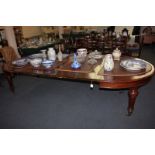 A Victorian mahogany extending dining table, from circular shape to oval with three extra leaves and