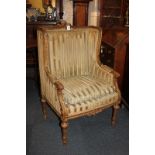 A 19th century French gilt exposed frame upholstered armchair with floral cornucopia surmount, the