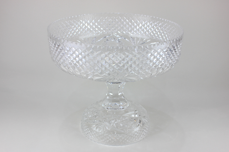 A cut glass pedestal fruit bowl, circular shape with diamond pattern border, on separate base with