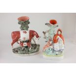 Two Staffordshire pottery spill vases modelled as a cow and calf, 28cm, and Red Riding Hood beside a