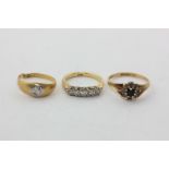 A diamond five-stone ring in 18ct gold, a gypsy set diamond ring in 18ct gold, and a sapphire