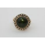 A cat's eye green tourmaline and diamond dress ring in 14ct