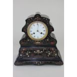 A 19th century black lacquered mantel clock, the scalloped case with brass, mother of pearl and