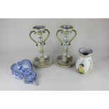 A pair of 19th century French faience pottery candlesticks depicting birds of paradise, one signed