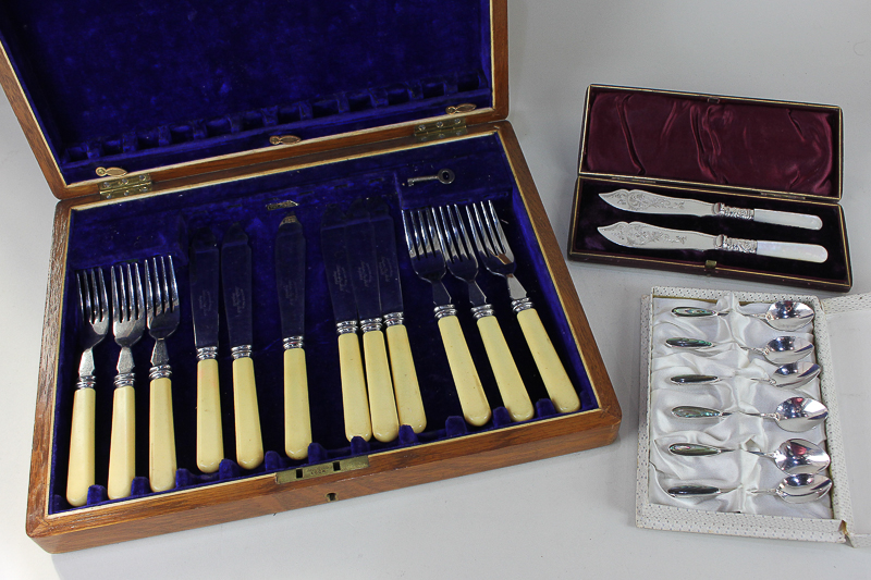 A pair of silver plated and mother of pearl fish knives in fitted case, six coffee spoons in