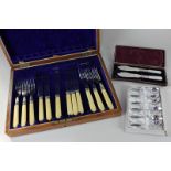 A pair of silver plated and mother of pearl fish knives in fitted case, six coffee spoons in