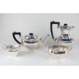 A George V silver four-piece tea set comprising teapot, water jug, cream jug and sugar bowl, oval