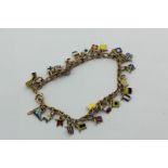 A 9ct gold bracelet hung with many gold and enamel flag pendants, 16.1g gross