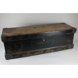 An early 20th century pine trunk with metal strengthened corners and two iron handles, with lock and