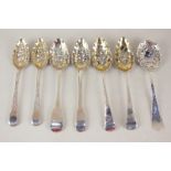 Six various George III and later silver berry teaspoons with embossed gilt bowls, and an Edwardian