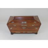 A 19th century mother of pearl inlaid rosewood tea caddy of sarcophagus form with two ring