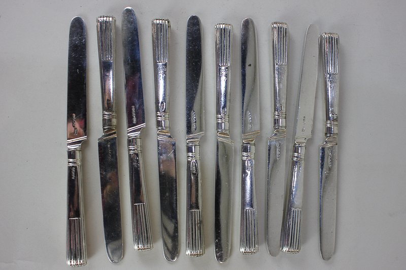 A set of ten William IV silver table knives with half demi-fluted handles, engraved armorial and