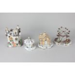 Three various Staffordshire pottery pastille burners modelled as cottages, to include one with