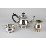 A George V silver three-piece bachelor tea set of teapot, cream jug, and two-handled sugar bowl,