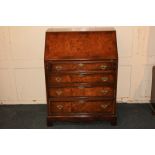 A walnut bureau with cross-banded fall enclosing fitted interior of pigeon holes and drawers,