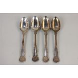 A set of four Victorian silver shell and scroll pattern dessert spoons, maker George William