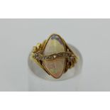 An opal and diamond ring of abstract form in 18ct yellow gold