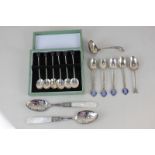 A set of four George V royal commemorative silver coffee spoons with monarch and consort