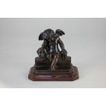 A late 19th century bronzed vanitas figure of a cherub seated on a step beside a skull and an