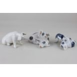 Three Royal Copenhagen porcelain models comprising two puppies playing, 6cm, two spotted pigs,