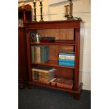 A mahogany bookcase with two adjustable shelves and reeded uprights, on bracket feet,