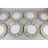 A set of eight Minton bone china plates with gilt decoration of floral and foliate borders on